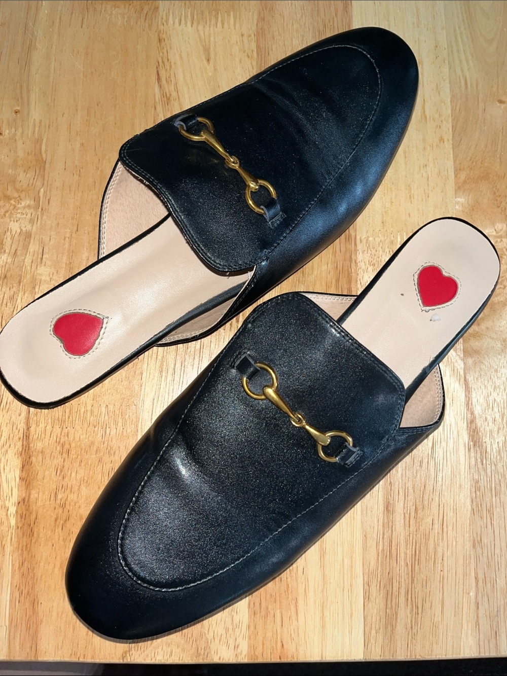 ARQA Black Backless Loafers with Gold Buckle Accent